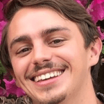 Smiling man with flowers in background