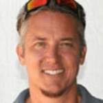 Smiling man with sunglasses on head