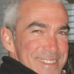 Smiling man with short gray hair