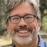 Cheerful person wearing glasses outside